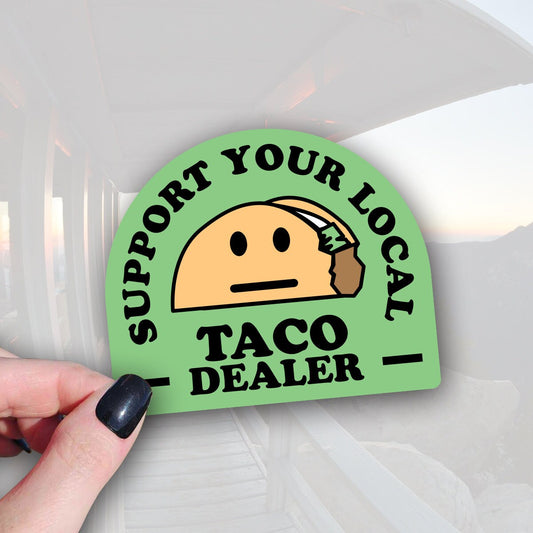 green sticker that says support your local taco dealer with an image of taco with a face